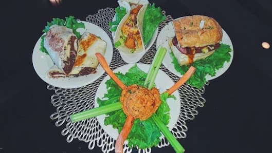 An overhead view of small plates and sandwiches at Café Nola
