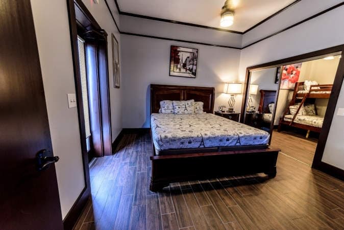 Presidential Family room with a wooden bed and an adjoining bunk room